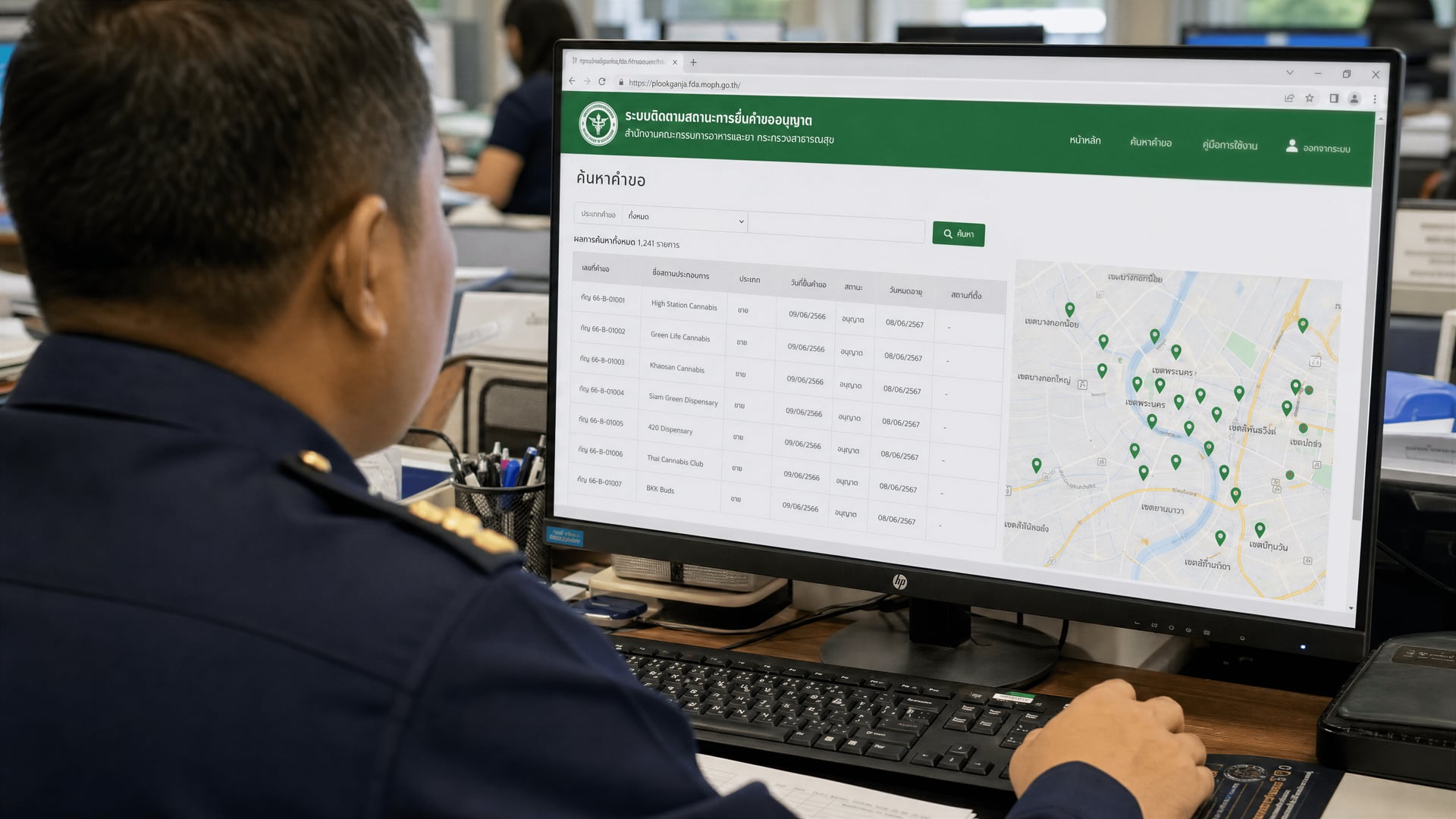 Thai officials reviewing GPS-pinned dispensary licences and expiry dates on a government website