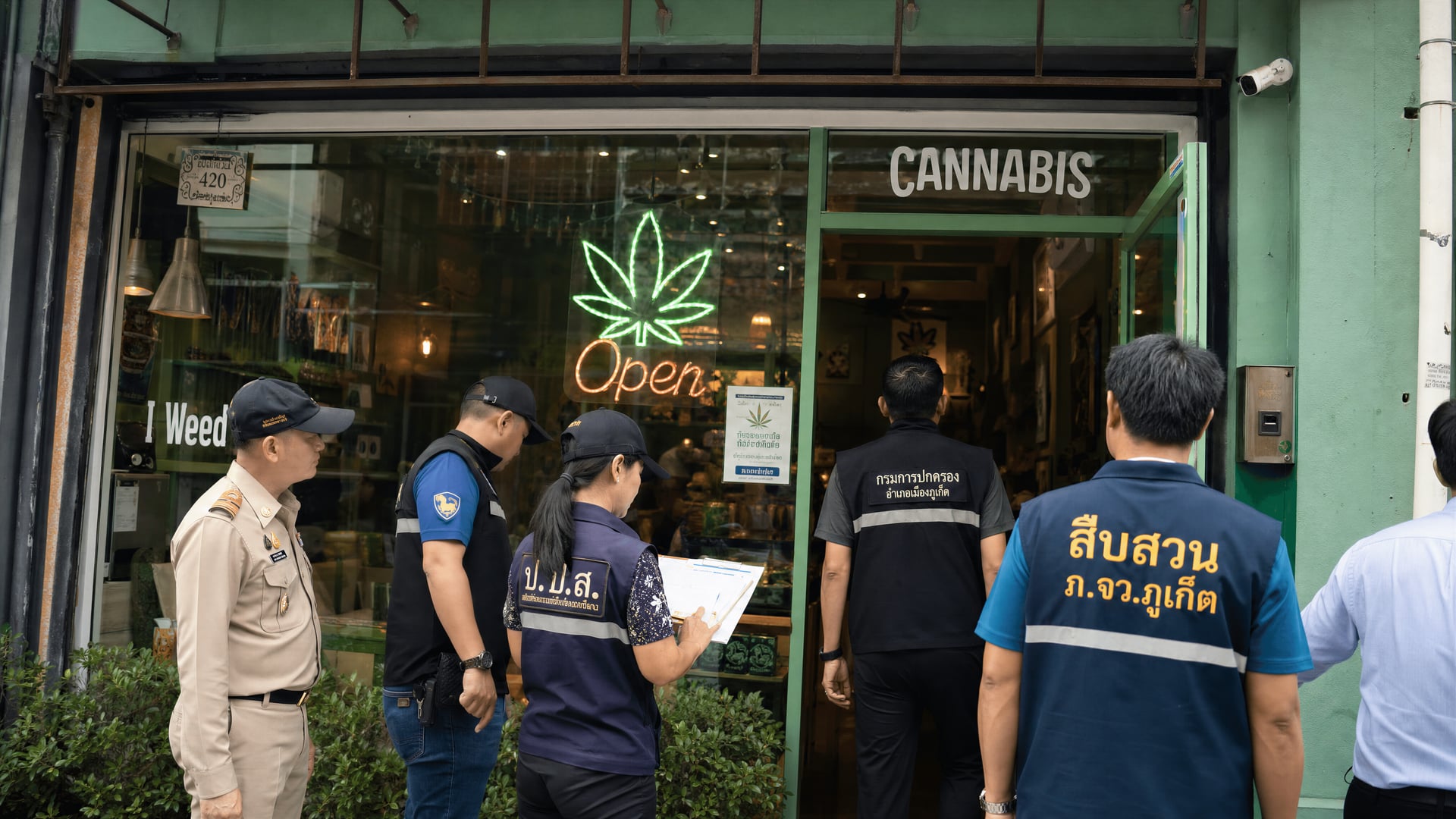 Provincial officials inspect permits outside a cannabis shop in Phuket Old Town